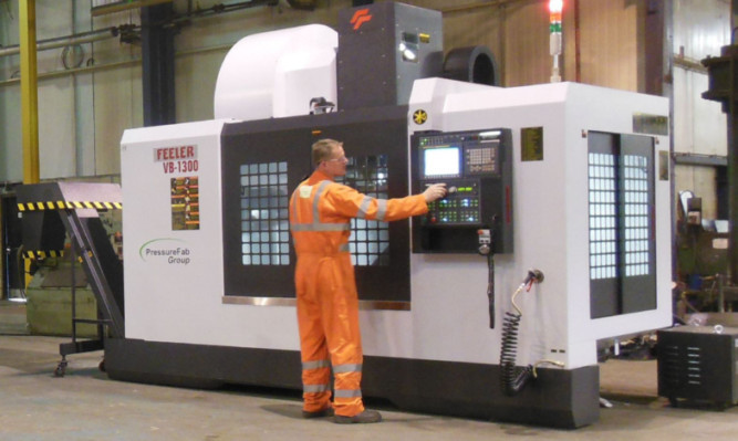 An operator on one of the new multi-axis live tool lathes at PressureFab.