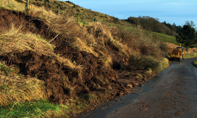 Heavy rain washed part of the embankment on to the Kirkton of Mailer road.