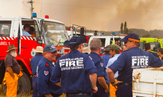Firefighters await instructions in the Kybeyan Valley, New South Wales.