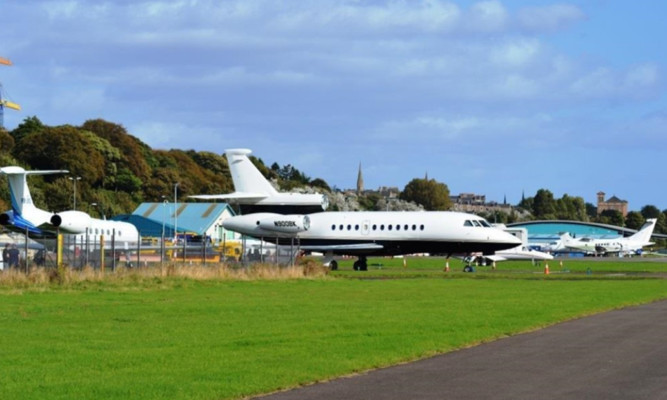 Private jets and helicopters at Dundee Airport.