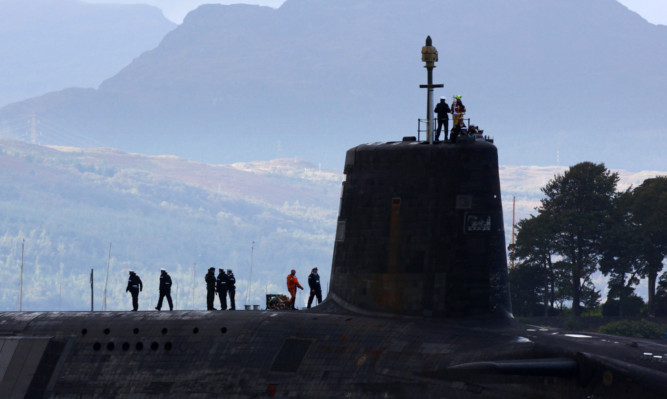 A submarine makes its way out of Faslane naval base.