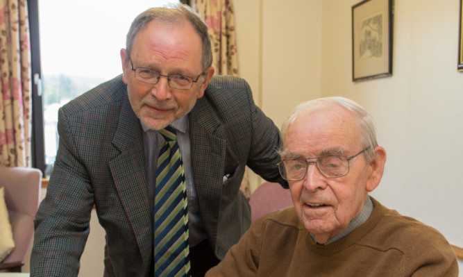 Councillor Tim Brett visits resident Dave Brown as he waits for daily hot food at his sheltered housing complex.