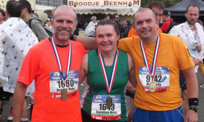 From left: Rob Hoey, Caroline Ness and Neil Hoey at the Amsterdam marathon.