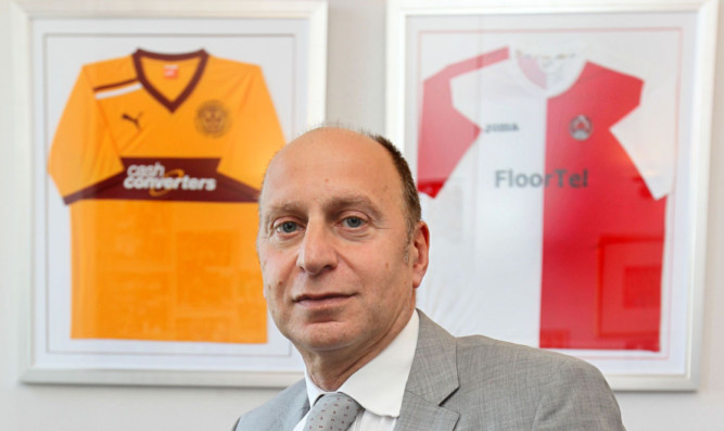 Bryan Jackson, chartered accountant and football administrator, is flanked by framed Motherwell FC and Clyde FC tops, two of the clubs he's helped save from closure.