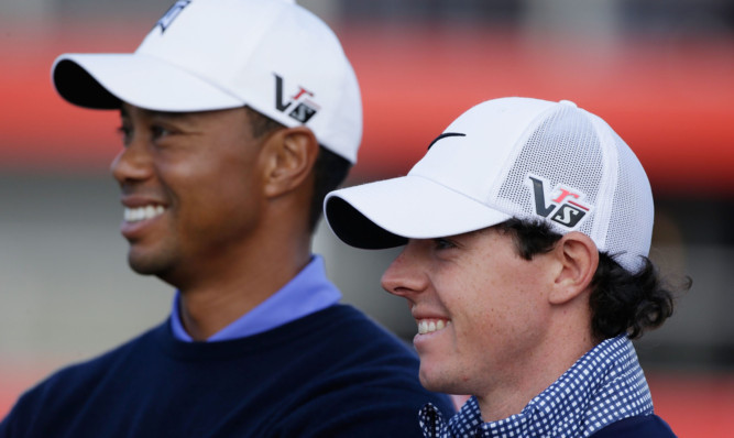 Tiger Woods of the USA and Rory McIlroy of Northern Ireland pose together during a photo call prior to the start of the Abu Dhabi HSBC Golf Championship at Abu Dhabi Golf Club on January 15, 2013 in Abu Dhabi, United Arab Emirates. *** Local Caption *** Tiger Woods; Rory McIlroy