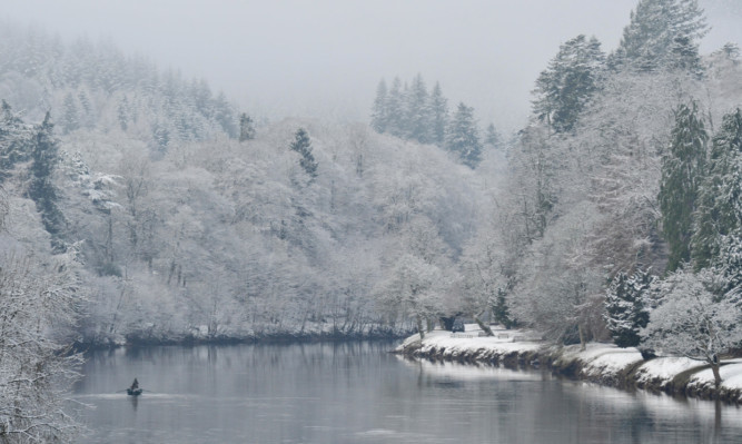 A fisherman braves the icy conditions in the River Tay at Dunkeld this week.