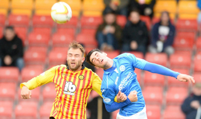 Brian Graham in an aerial battle with Partick Thistle's Conrad Balatoni.
