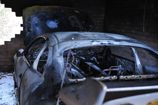 The burned-out car.