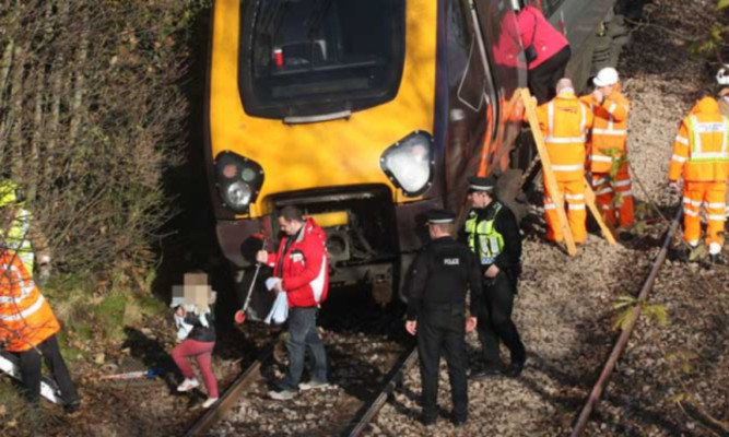 Passengers being led to safety after last year's derailment.