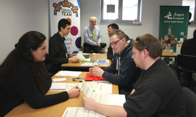 Angus Council staff from the Welfare Rights Service in conversation with some of the workers.