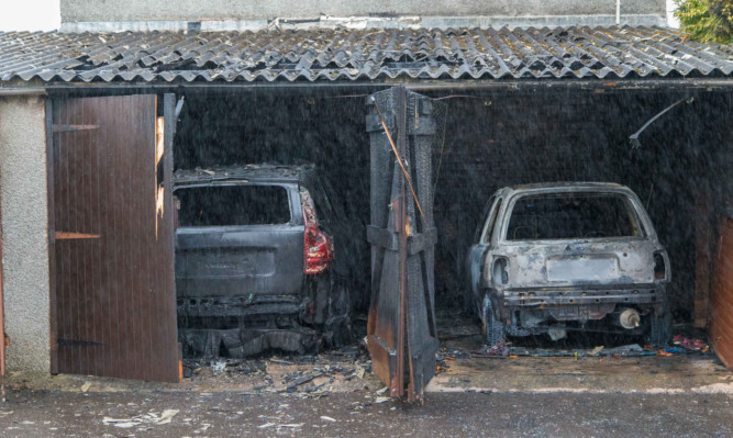 Two of the cars destroyed in Monday's fire attack in Sinclair Avenue.