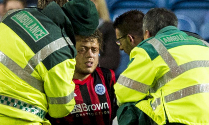 St Johnstone's Murray Davidson receives treatment after suffering a head knock.