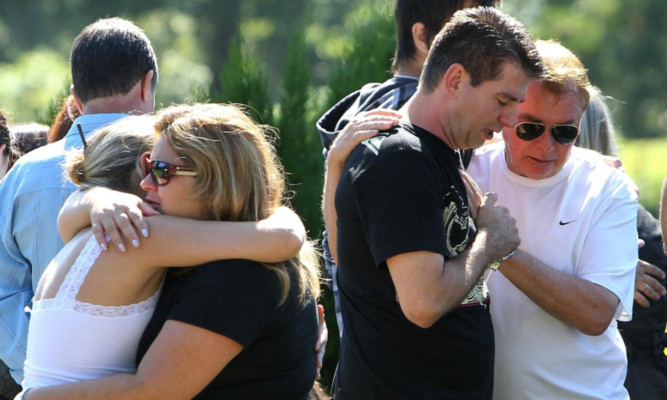 Family members mourn one of the victims.