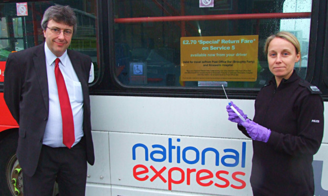 National Express managing director Phil Smith and PC Gill Grant with the spit kit.