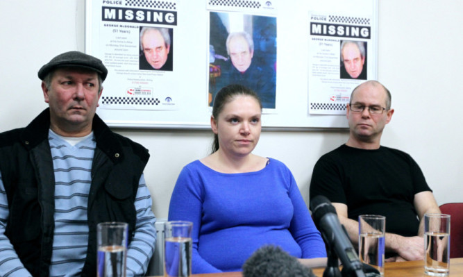 Jean McDonald makes a statement to the media at Alloa police station alongside George's brothers William (left) and Lewis.