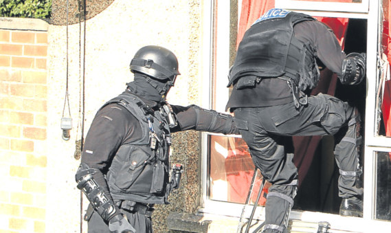 Police during an earlier drugs raid on a flat in Dundee.