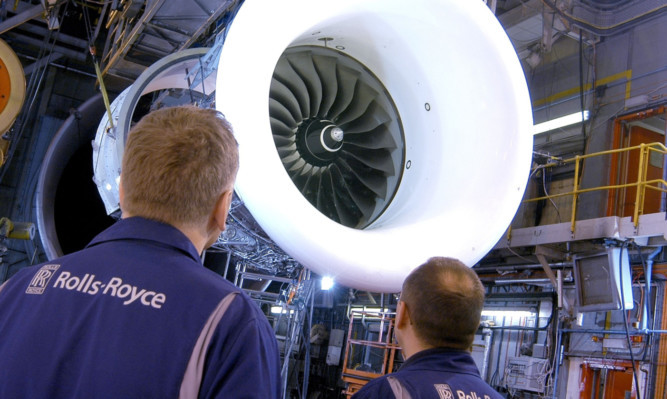 Rolls-Royce engineers inspect a Trent 1000 engine. The firm is cutting 2,600 jobs in a restructuring programme.