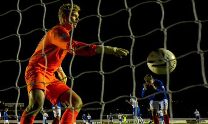 Cowdenbeath's Kyle Miller attempts to clear the ball, which ends up in the back of his own net doubling the lead for Rangers.