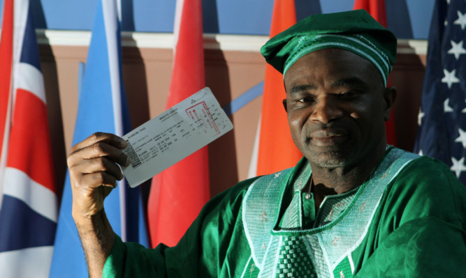 Pastor Joe Nwokoye with his boarding pass showing the stamp (in red) to show he had been screened for ebola.