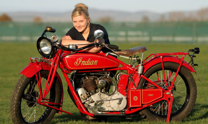 Auction administrator Ashley Winchester with the 1922 Indian Scout.