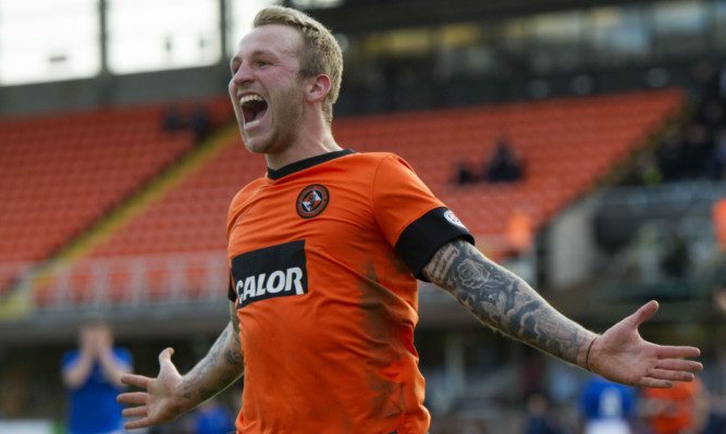 Johnny Russell celebrates completing the scoring for Dundee United.