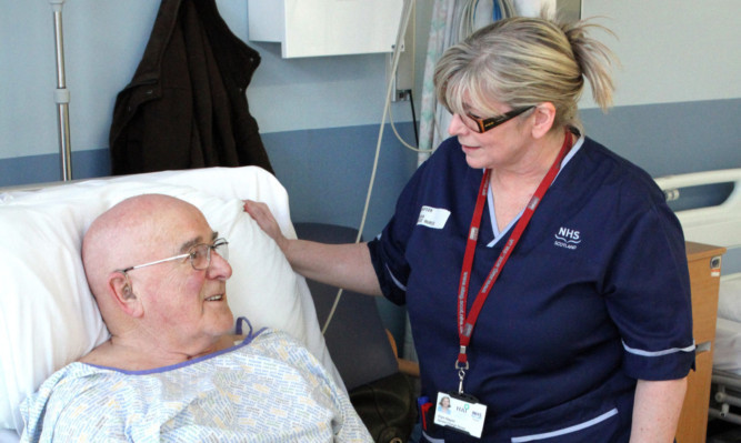Kris Miller, Courier, 01/02/13. Picture today at the new AMU unit in Ninewells shows Senior Charge Nurse Pam Napier talking to patient, Alex Bertie.
