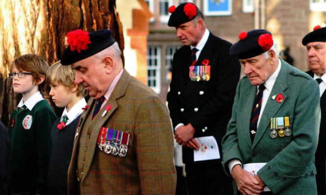 Major Ronnie Proctor, front, with veterans in prayer during the service.