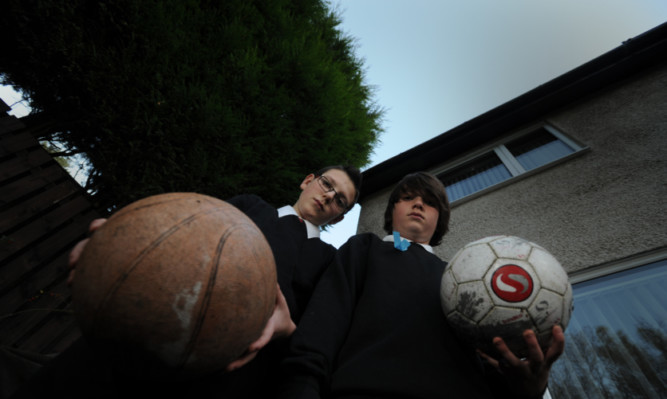 Innes and Blair Roberts in their Larch Avenue back garden in Glenrothes, where the neighbours hedge is now taller than the eaves of their home.