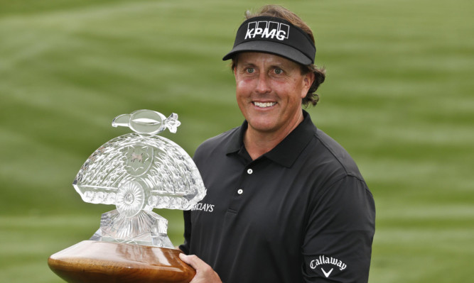 Phil Mickelson with the Waste Management Phoenix Open trophy.