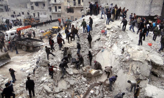 Pictures broadcast on Syrian state TV show people searching through the debris of destroyed buildings after airstrikes in Aleppo.