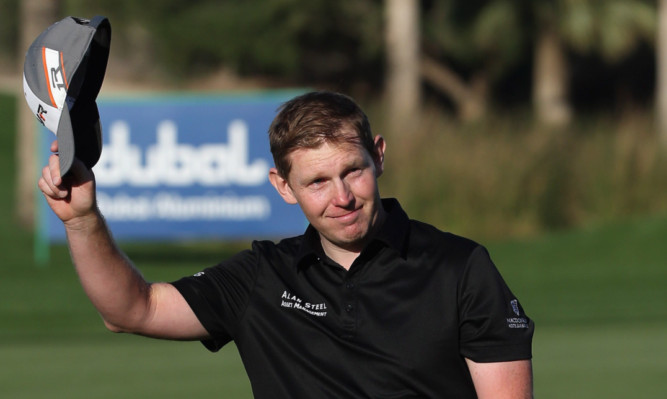 Stephen Gallacher waves to the crowd during the final round of the Omega Dubai Desert Classic.