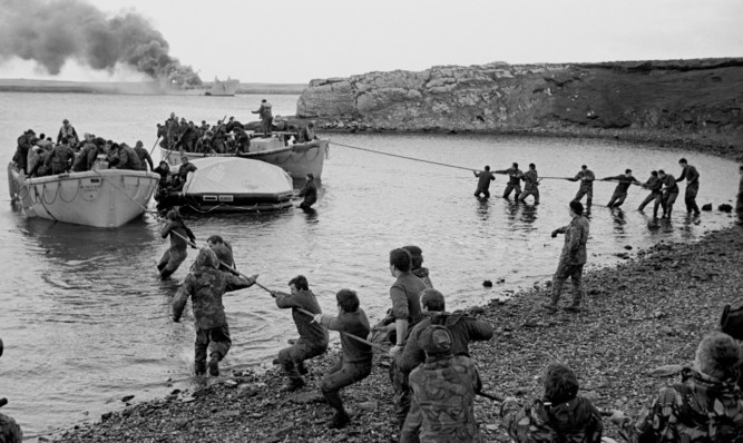 Survivors of the Argentine attack on the Sir Galahad make it to shore during the 1982 Falkland Islands war.