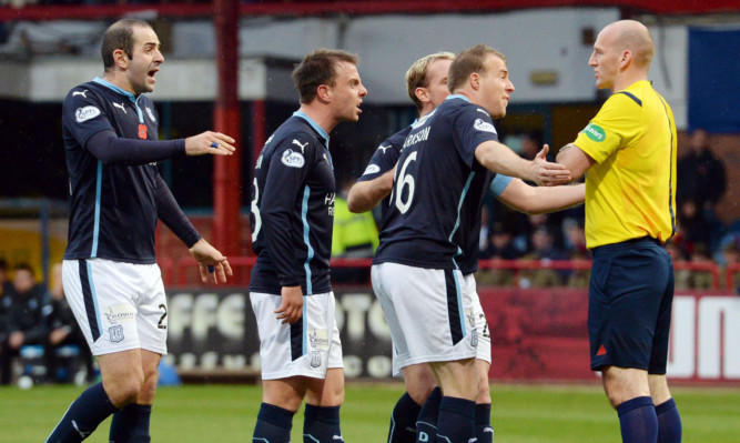 undee's David Clarkson (second from right) appeals to referee Bobby Madden as he receives a booking.