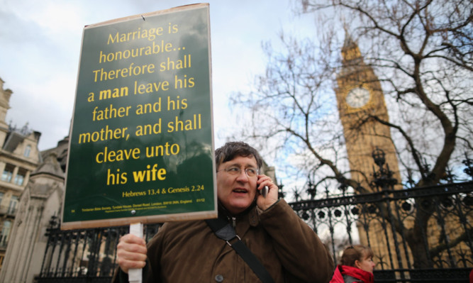 A protester outside Parliament before last night's vote.