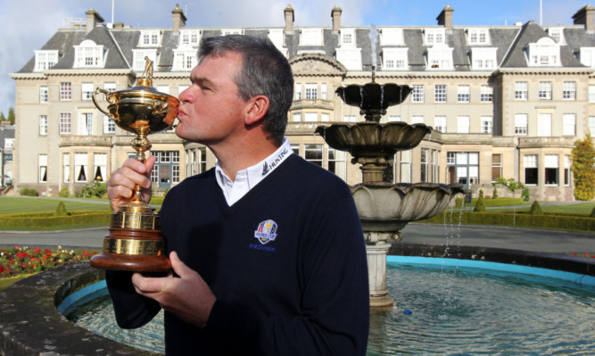 A kiss for good luck  Scottish golfer Paul Lawrie with the Ryder Cup at Gleneagles.