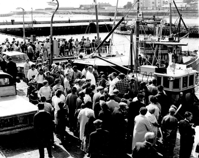After news that the last white fish trawler in Arbroath has been sold, we take a look through the DC Thomson archives to witness the harbour's heydays. This image shows holidaymakers enjoying the spectacle of the fish sales in 1968.