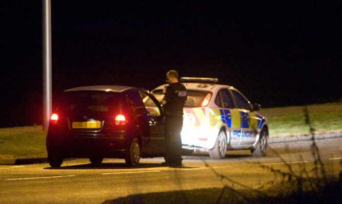 Police talking to a motorist during last night's incident.