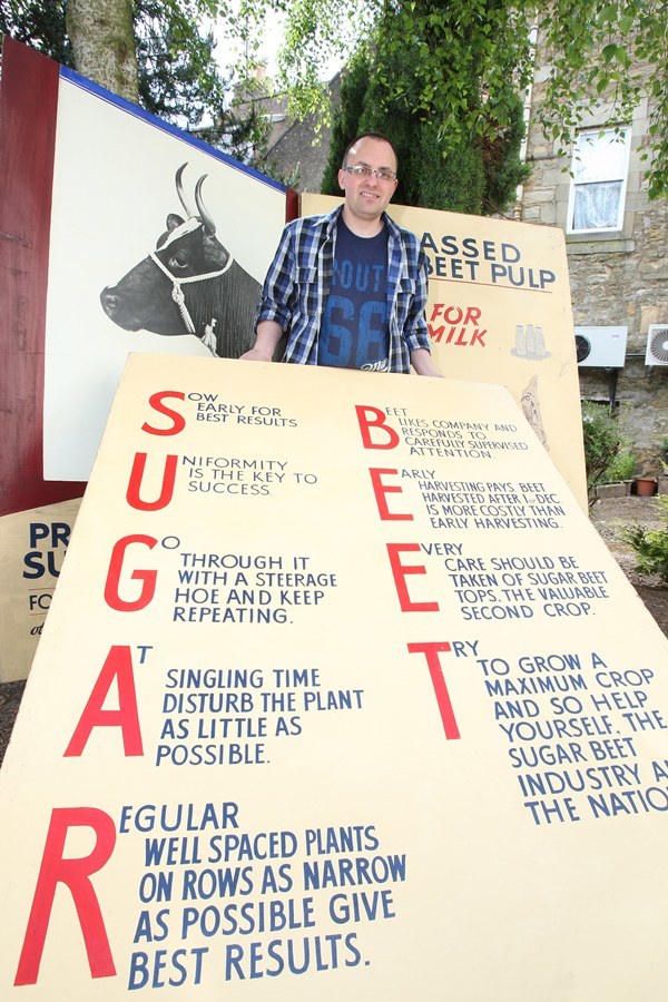 Kris Miller, Courier, 02/05/10, News. Picture today off Crossgate, Cupar. Pic shows local historian, Steve Penrice with signs from the old Sugar Beet factory. Steve is trying to find out more about the history of the signs. See Cupar for story.