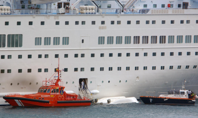 Tthe capsized lifeboat beside the Thomson Majesty.