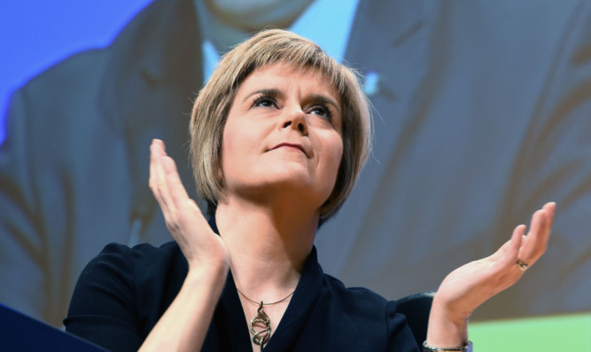 New SNP leader Nicola Sturgeon listens to Mr Hosie's speech.