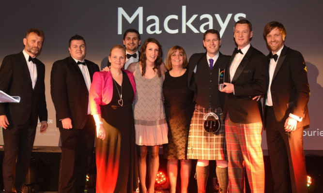 The Mackays team take the stage to accept their award.