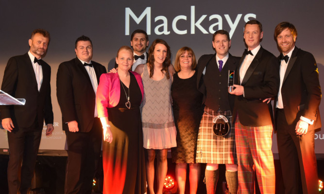 The Mackays team on stage to receive their main award.