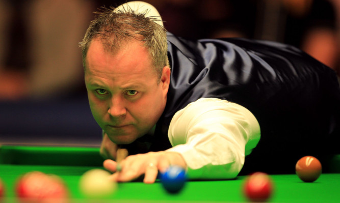 John Higgins in action against Shaun Murphy during day five of the Betfair Masters at Alexandra Palace, London.