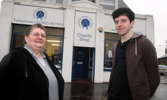 Shop manager Theresa Canning swith volunteer Michael McFarlane.