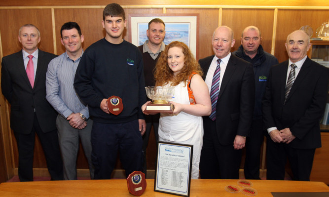 Kirsten Finnie is presented with the Bill McKay trophy while apprentice electrician David Robertson was named runner-up.