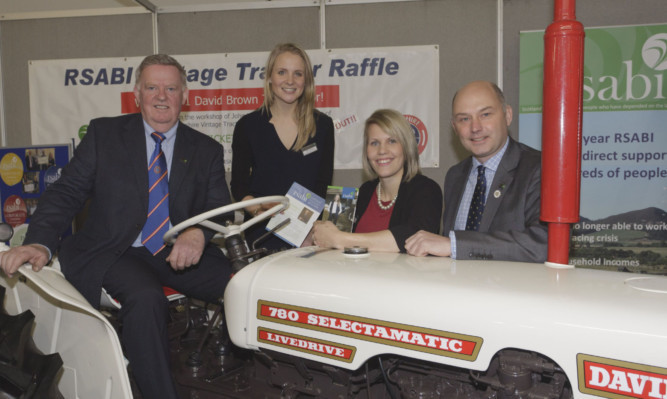 Russell McNab, Tessa Rouse and Melissa Kelly of RSABI and Paul Tinson with the David Brown tractor which was won by Stephen Urquhart.