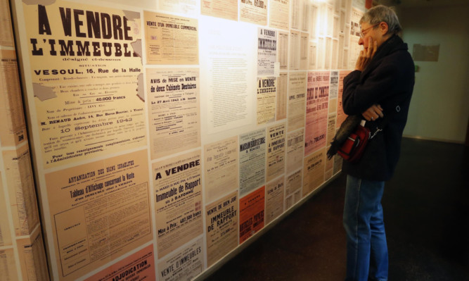 Posters of seizure orders are displayed in an exhibition at the Shoah Memorial in Paris.