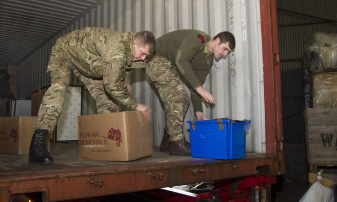 Marines help to pack the goods off to Malawi.