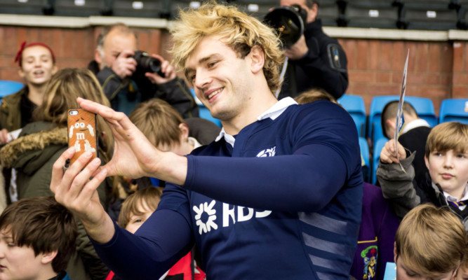 Scotland lock Richie Gray takes a selfie with young fans at yesterday's final training session at Rugby Park.