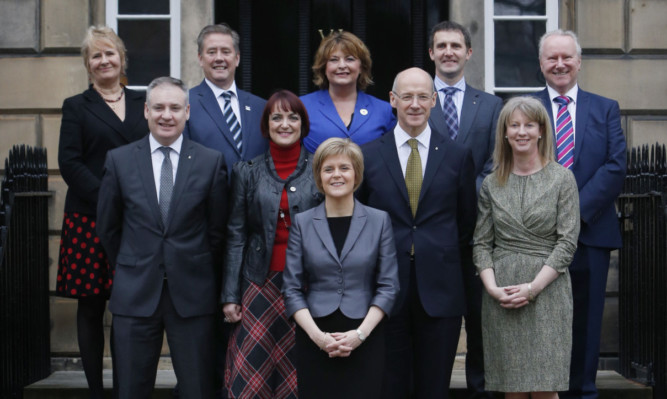 First Minister Nicola Sturgeon stands in front of her new cabinet on the steps of Bute House in Edinburgh. Back from left: Roseanna Cunningham, Secretary for Fair Work, Skills and Training; Keith Brown, Secretary for Infrastructure, Investment and Cities; Fiona Hyslop, Culture Secretary; Michael Matheson, Justice Secretary; Alex Neil, Cabinet Secretary for Social Justice, Communities and Pensioners Rights; front: Richard Lochhead, Environment Secretary; Angela Constance, Education Secretary; John Swinney, Deputy First Minister and Finance Secretary; and Shona Robison, Health Secretary.